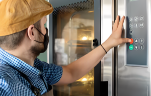 man putting cheesecake in fridge 